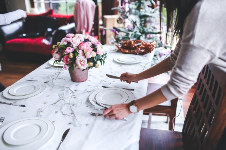 woman setting table for nice dinner