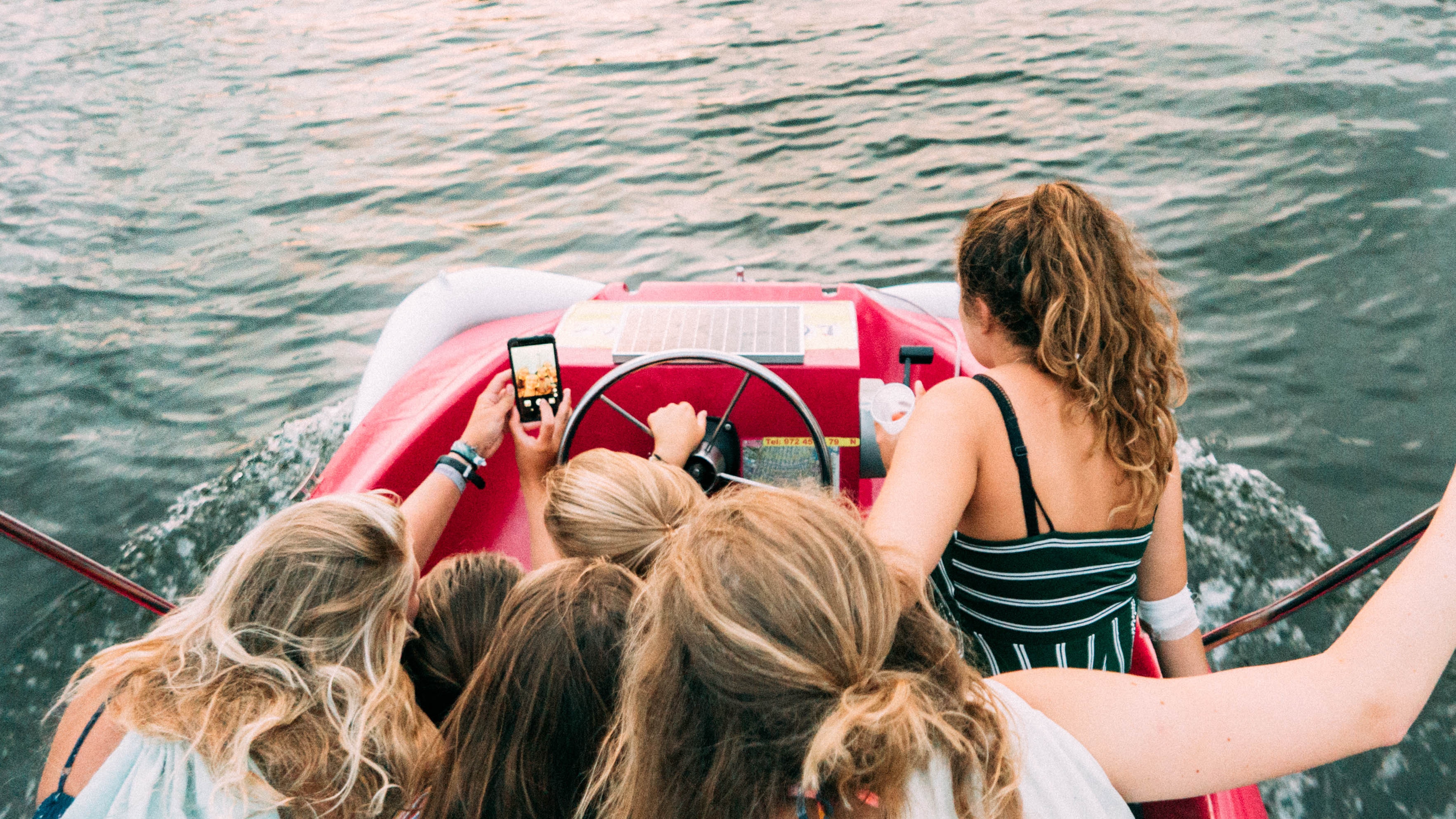 teen girls on boat taking a selfie together